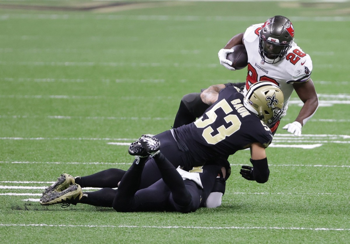 Jan 17, 2021; New Orleans, LA, USA; Tampa Bay running back Leonard Fournette (28) is tackled by Saints outside linebacker Zack Baun (53) during the first quarter in a NFC Divisional Round playoff game at Mercedes-Benz Superdome. Mandatory Credit: Derick E. Hingle-USA TODAY Sports