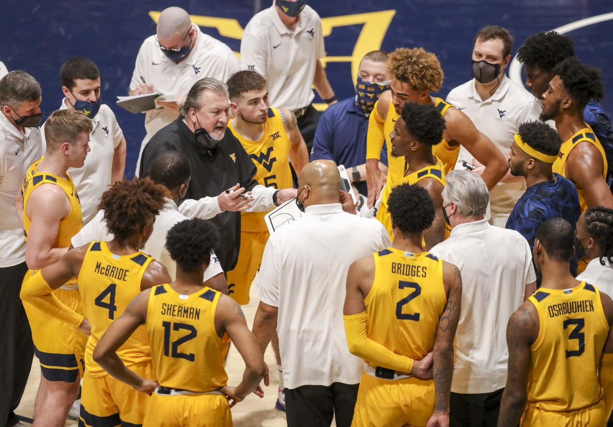 Jan 30, 2021; Morgantown, West Virginia, USA; West Virginia Mountaineers head coach Bob Huggins talks to his team during a timeout during the first half against the Florida Gators at WVU Coliseum.
