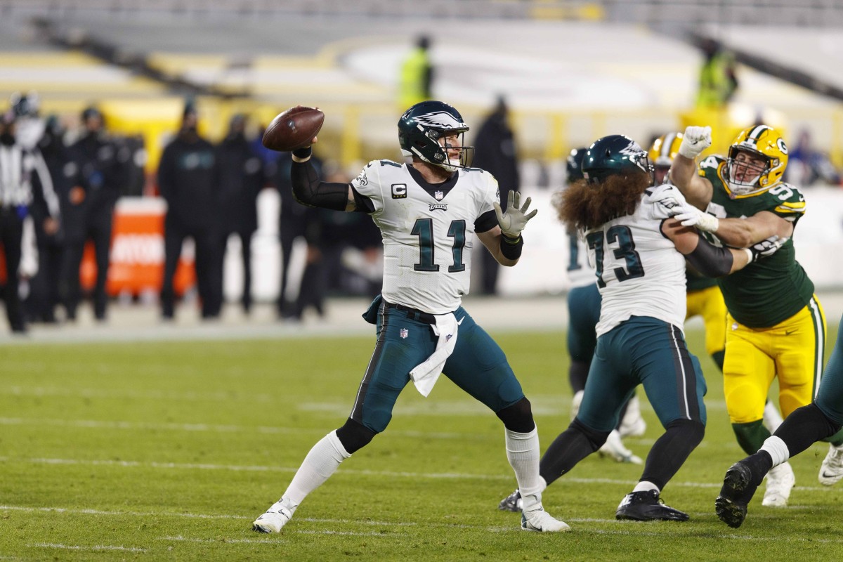 Dec 6, 2020; Green Bay, Wisconsin, USA; Philadelphia Eagles quarterback Carson Wentz (11) throws a pass during the second quarter against the Green Bay Packers at Lambeau Field. Mandatory Credit: Jeff Hanisch-USA TODAY Sports