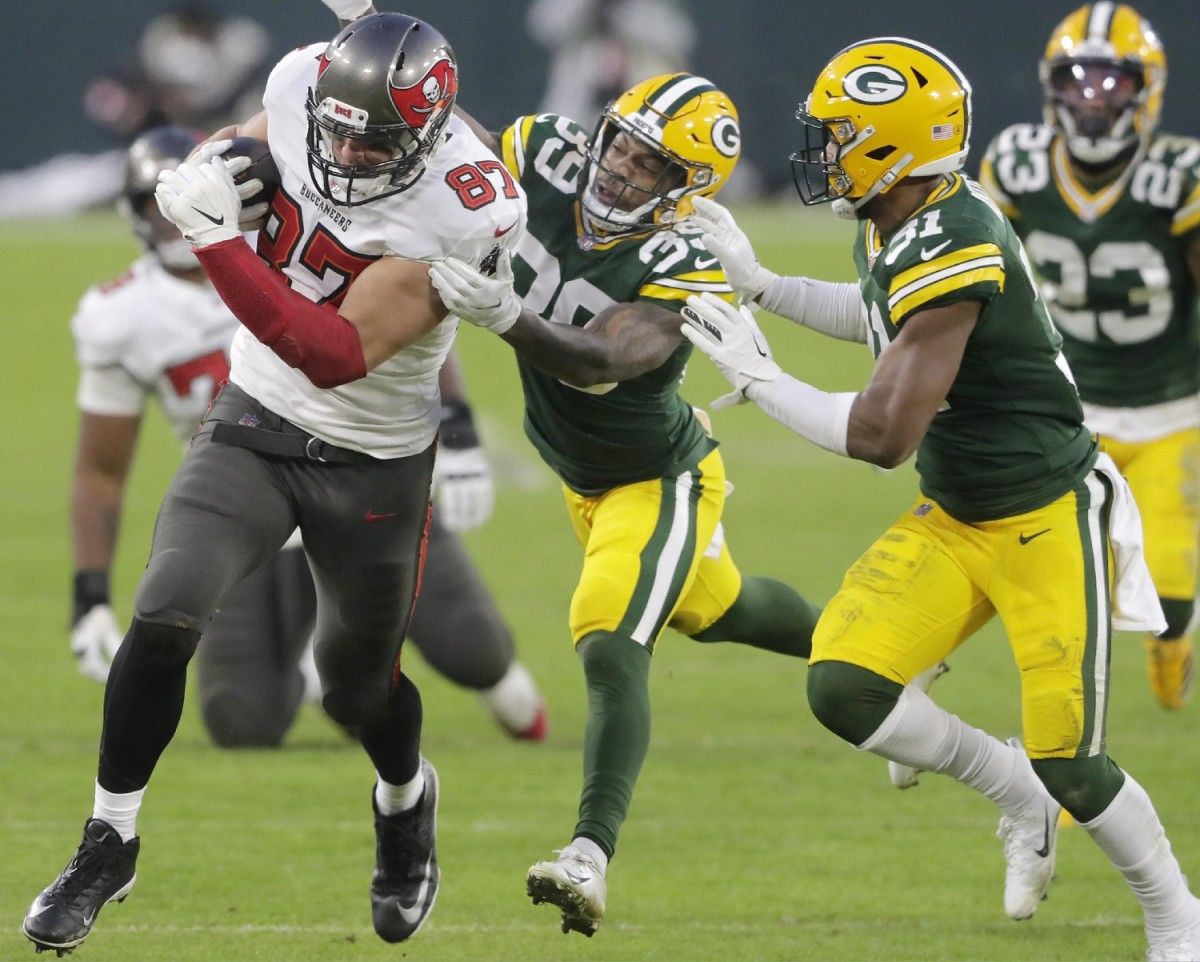 Tampa Bay Buccaneers tight end Rob Gronkowski (87) is chased tackled Sullivan (39) during the NFC championship game on Sunday, January 24, 2021, at Lambeau Field in Green Bay, Wis.