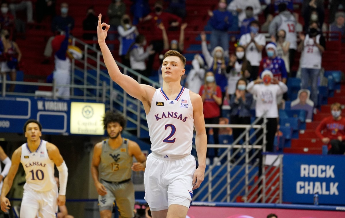 Dec 22, 2020; Lawrence, Kansas, USA; Kansas Jayhawks guard Christian Braun (2) celebrates after scoring a three point basket against the West Virginia Mountaineers during the second half at Allen Fieldhouse.