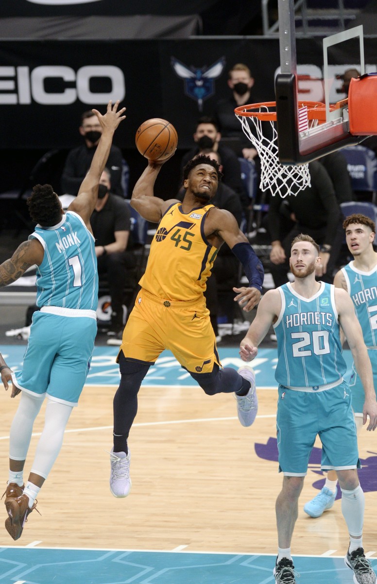 Donovan Mitchell (45) dunks over Malik Monk (1) in a game against the Hornets Friday night.