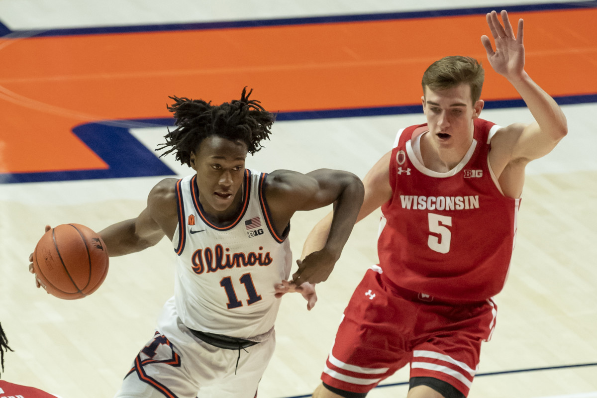 Illinois Fighting Illini guard Ayo Dosunmu (11) drives against Wisconsin Badgers forward Tyler Wahl (5) during the first half at State Farm Center. Dosunmu ended with a triple-double (21 points, 12 assists and 12 rebounds) in a 75-60 win over Wisconsin. 