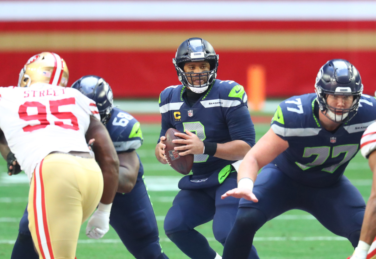 Seattle Seahawks quarterback Russell Wilson (3) drops back to pass against the San Francisco 49ers during the first half at State Farm Stadium.