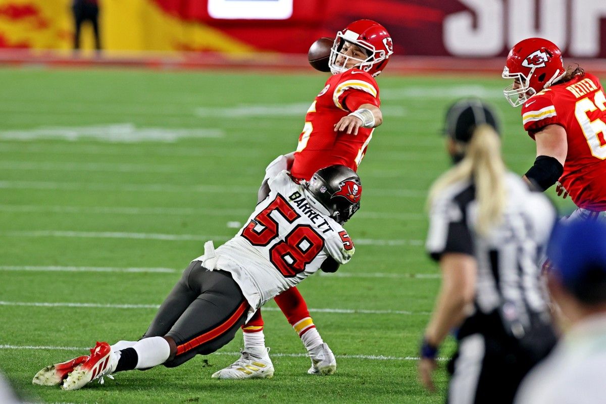 Kansas City Chiefs quarterback Patrick Mahomes (15) throws a pass under pressure from Tampa Bay Buccaneers outside linebacker Shaquil Barrett (58) during the fourth quarter in Super Bowl LV at Raymond James Stadium.