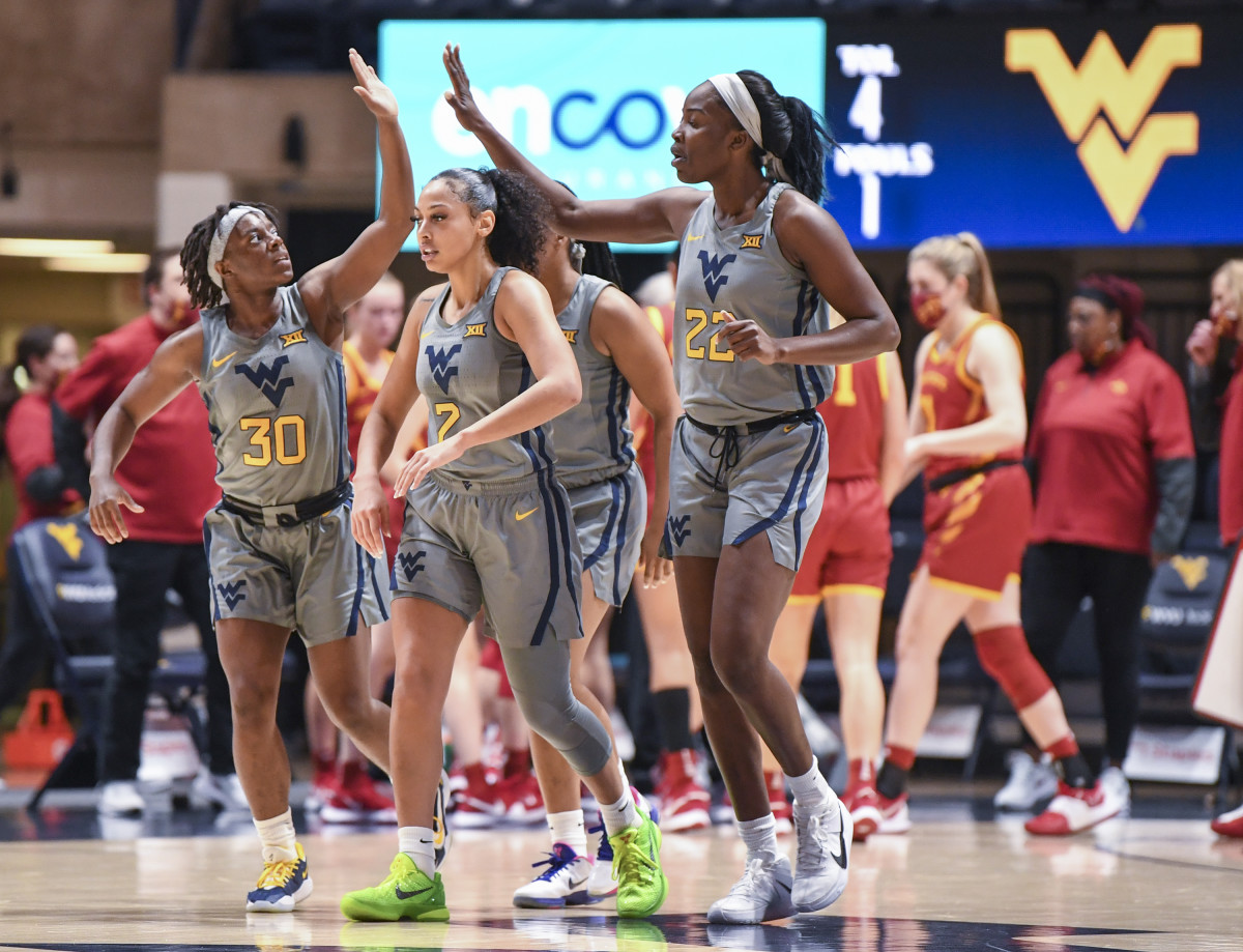 West Virginia guards Madisen Smith (30) and Kysre Gondrezick (2) and Center Blessing Ejiofer (22).