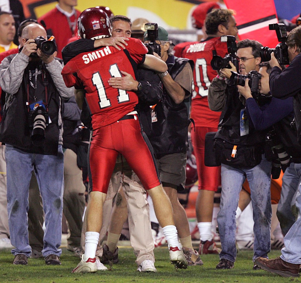 Alex Smith hugs his college Urban Meyer following a victory during the 2004 college football season