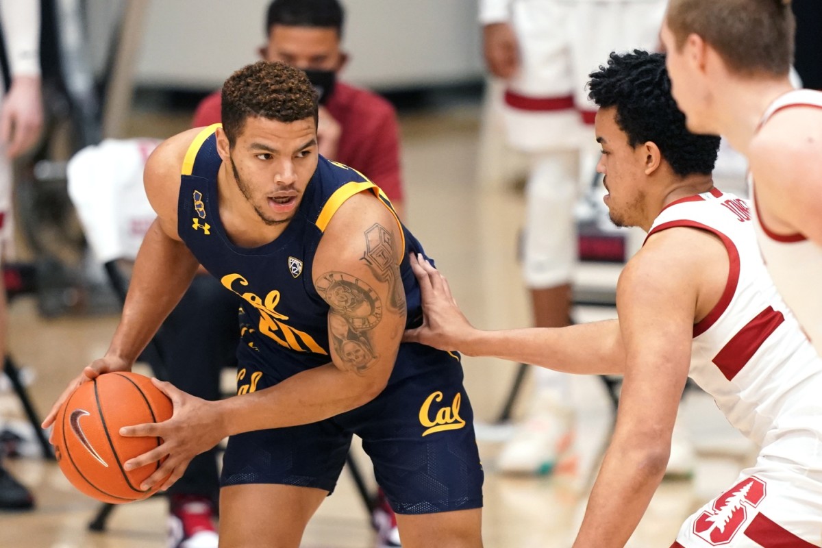 Feb 7, 2021; Stanford, California, USA; California Golden Bears guard Matt Bradley (20) handles the ball while being defended by Stanford Cardinal forward Spencer Jones (14) during the first half at Maples Pavilion.
