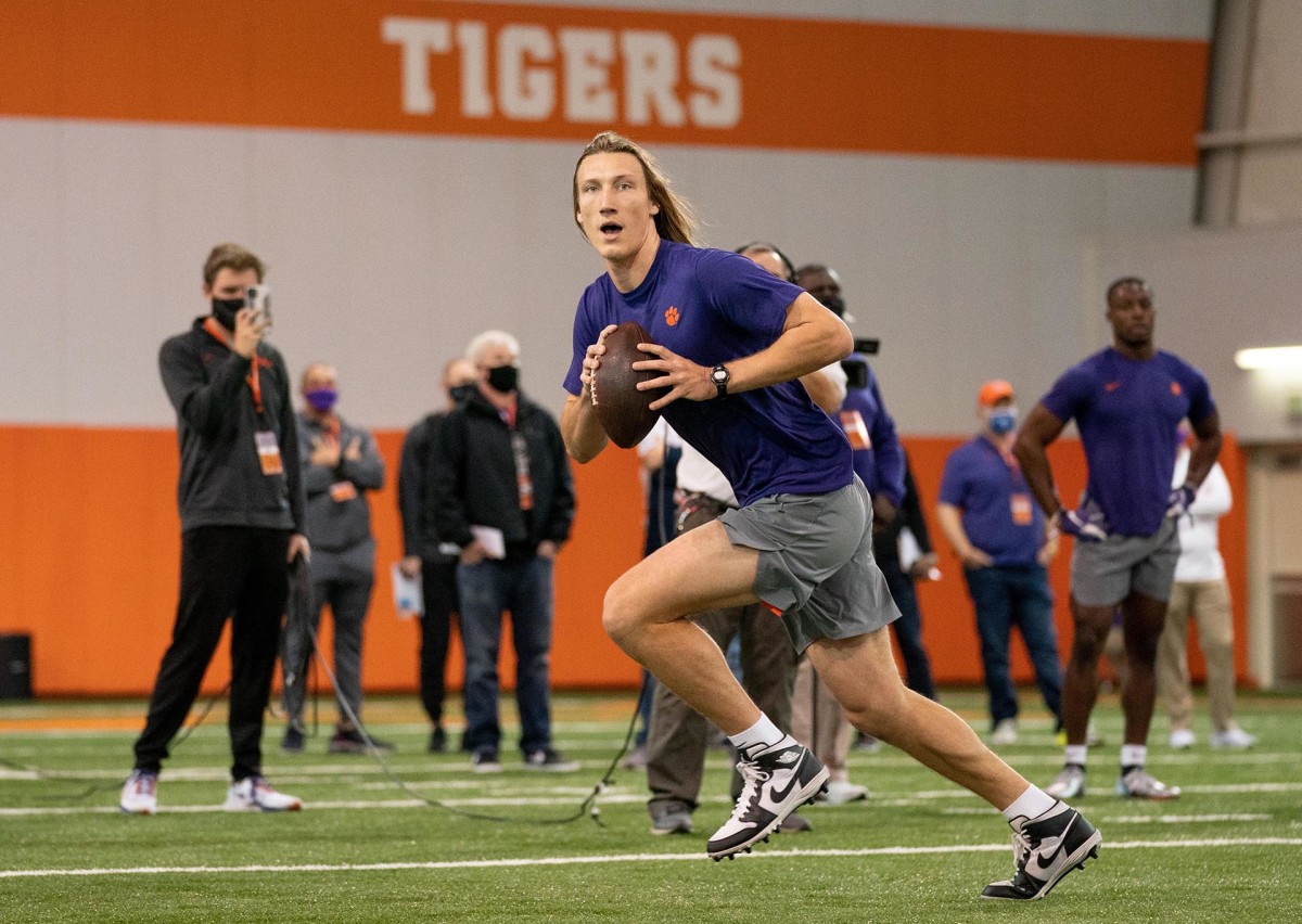 Trevor Lawrence throws on the run during his NFL draft pro day at Clemson