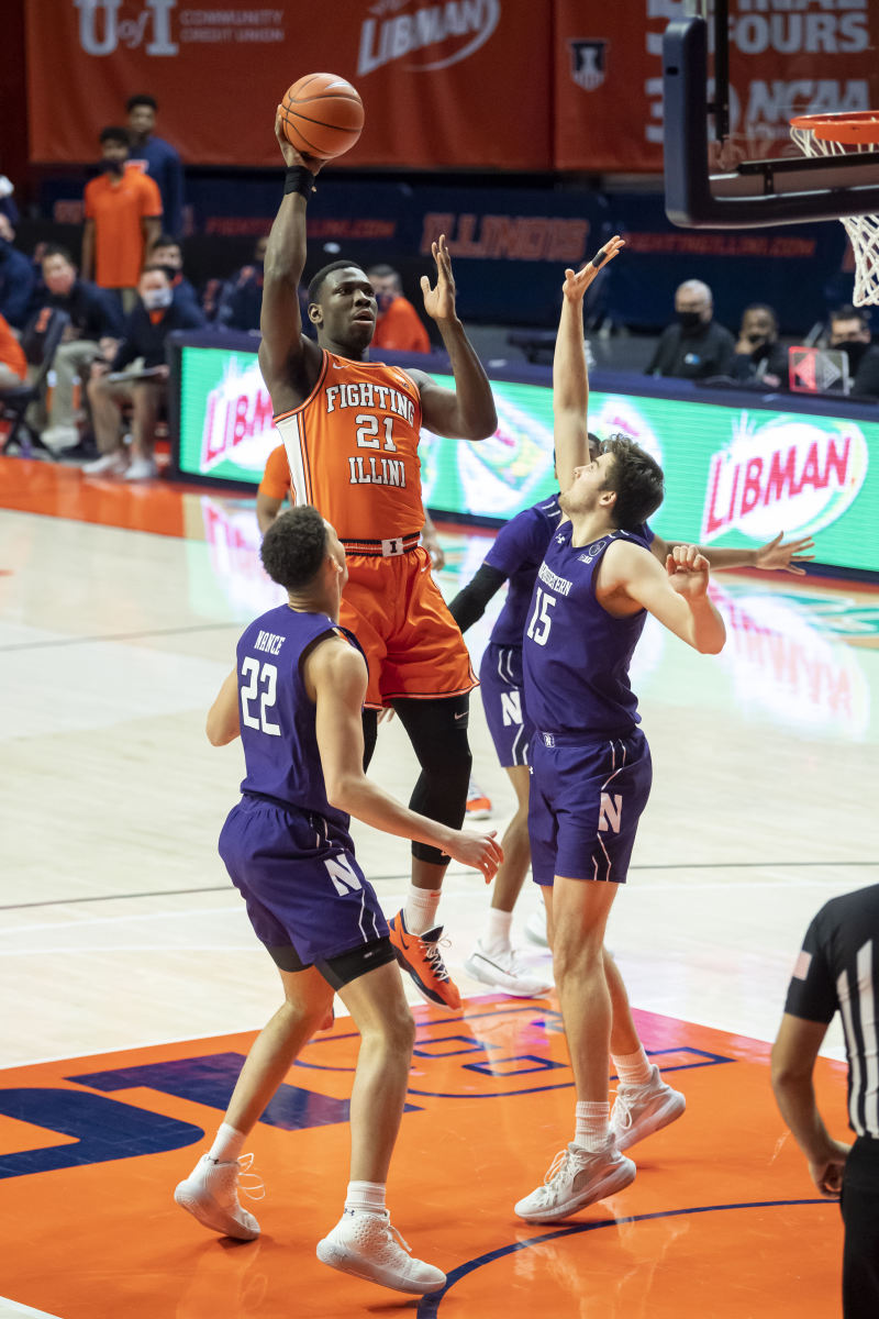 Illinois Fighting Illini center Kofi Cockburn (21) shoots against Northwestern Wildcats center Ryan Young (15) during the first half at the State Farm Center.