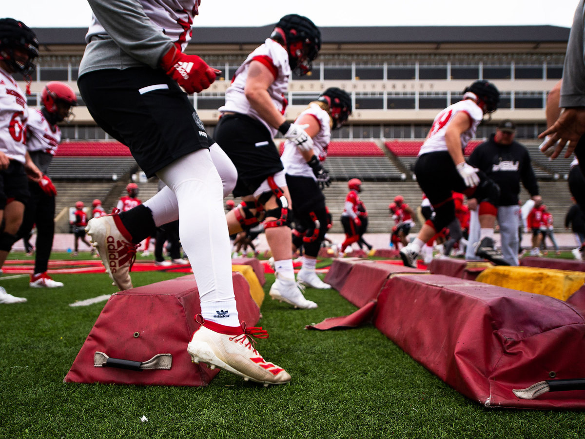 Jacksonville State football players run through drills