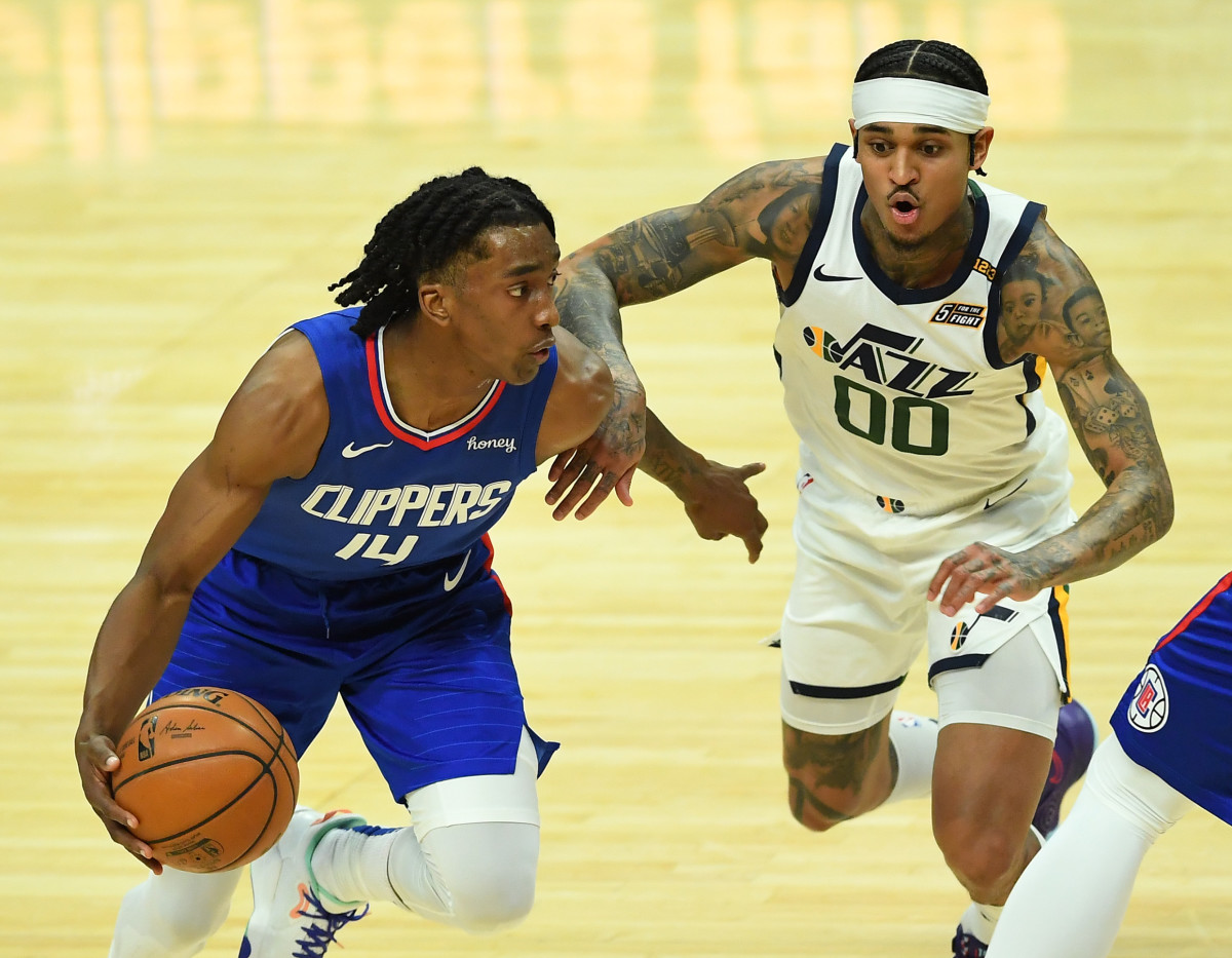 Feb 17, 2021; Los Angeles, California, USA; Los Angeles Clippers guard Terance Mann (14) is defended by Utah Jazz guard Jordan Clarkson (00) as he drives to the basket in the first half of the game at Staples Center. Mandatory Credit: Jayne Kamin-Oncea-USA TODAY Sports