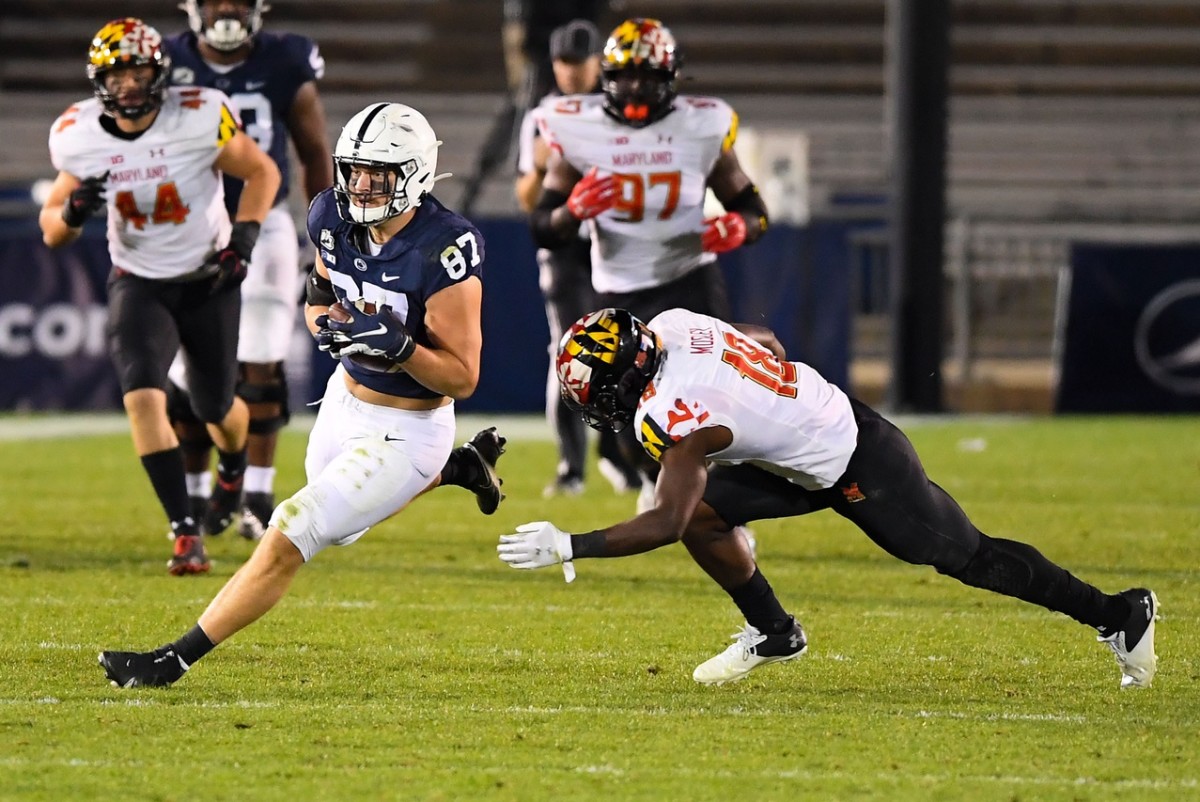 Nov 7, 2020; University Park, Pennsylvania, USA; Penn State Nittany Lions tight end Pat Freiermuth (87) runs with the ball after a catch as Maryland Terrapins defensive back Jordan Mosley (18) defends during the third quarter at Beaver Stadium.