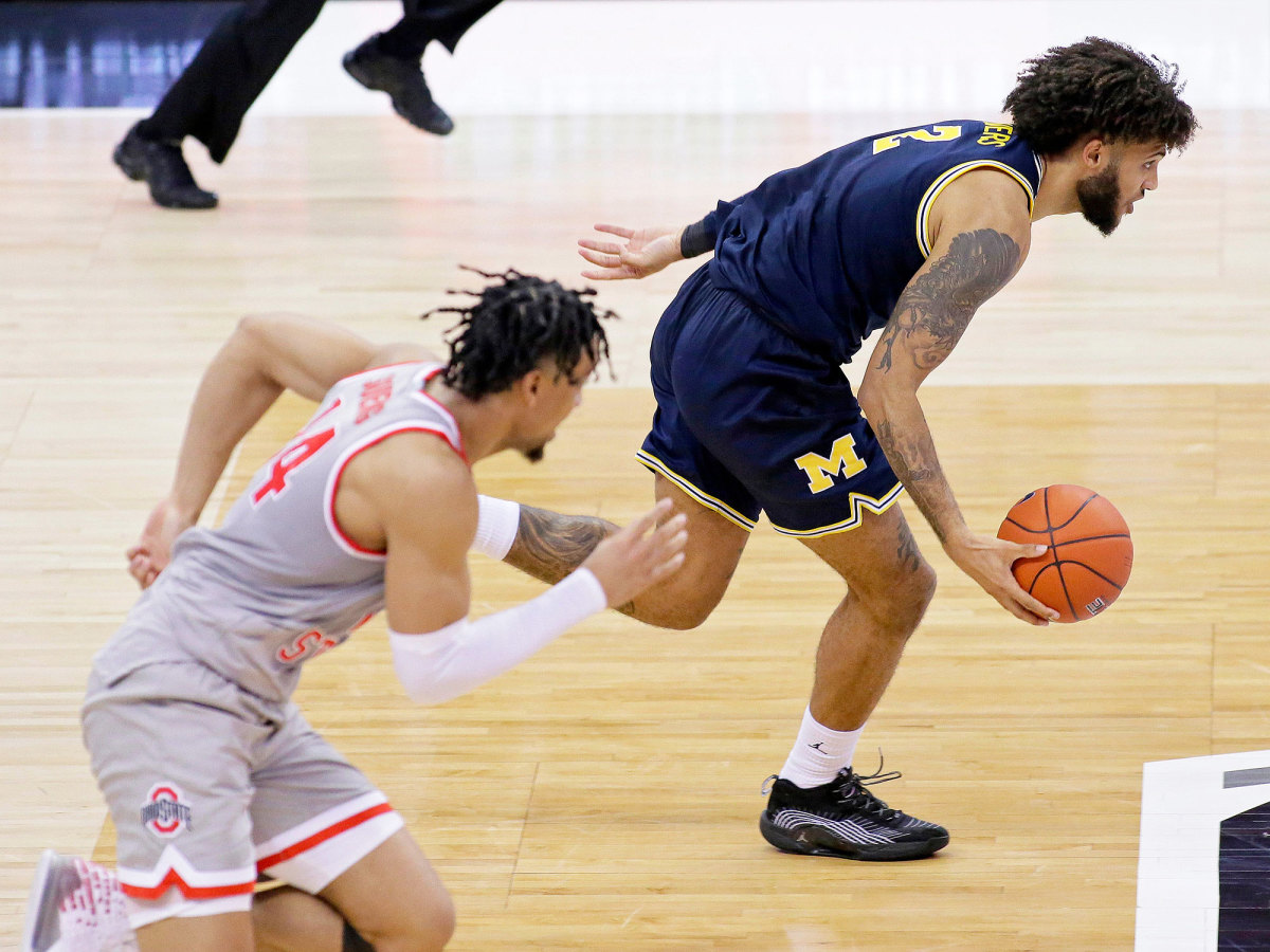 Michigan's Isaiah Livers dribbles away from Ohio State