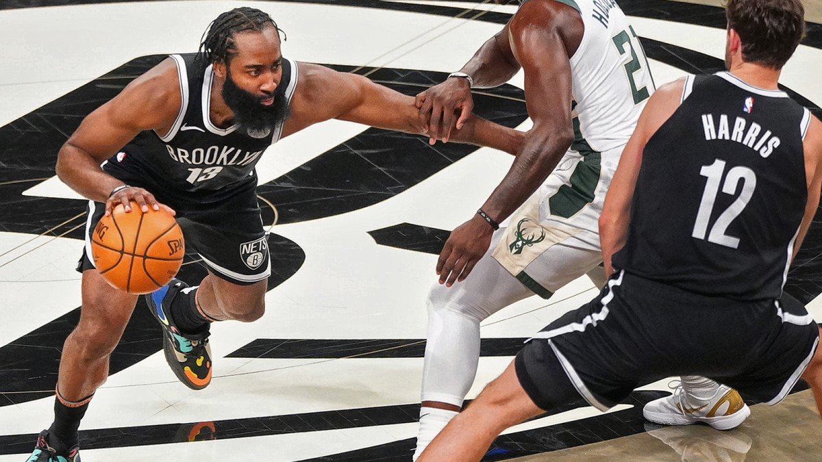 James Harden dribbles against the Bucks