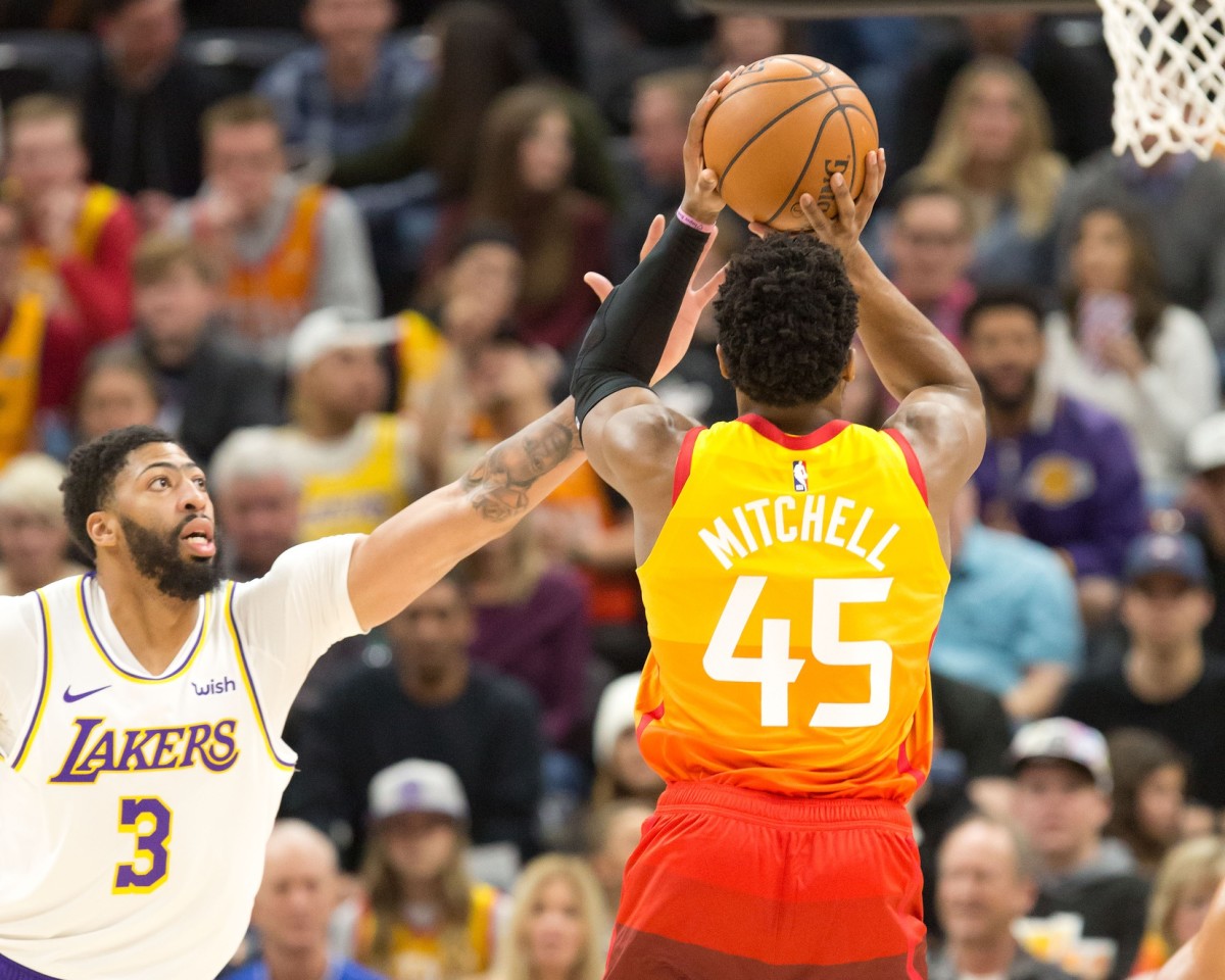 Donovan Mitchell (45) shoots a three pointer over Anthony Davis (3) during a game against the Lakers in 2019.