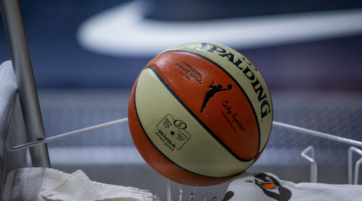 A game ball sits on a sanitation cart