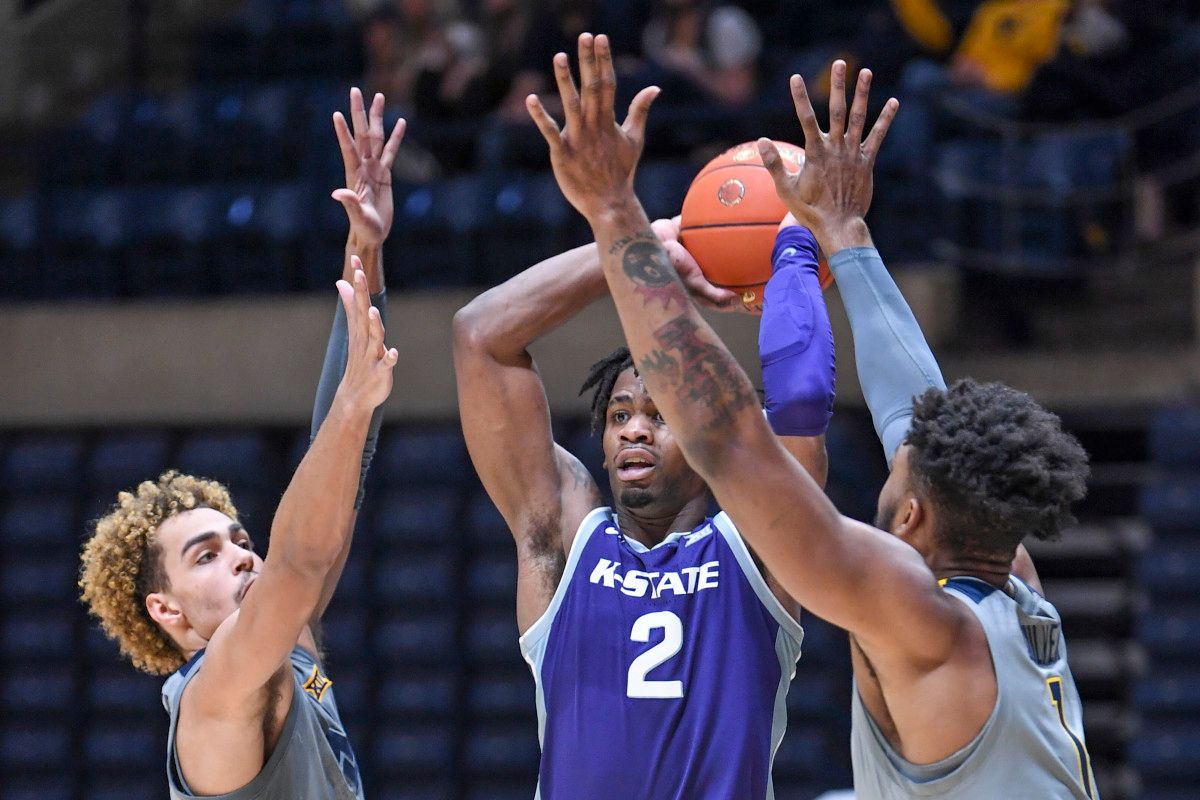 West Virginia forwards Emmitt Matthews Jr (left) and Derek Culver (1) harass Kansas State forward Selton Miguel (2).
