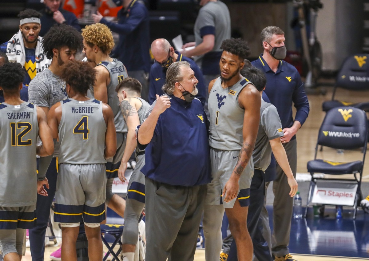 West Virginia Mountaineers head coach Bob Huggins talks with forward Derek Culver (1) during a timeout during the second half against the Kansas State Wildcats at WVU Coliseum.