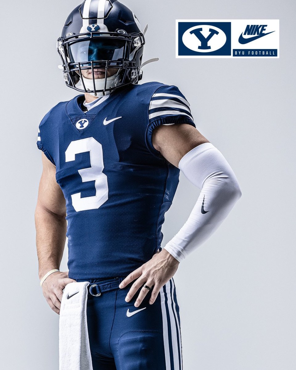 Byu football uniforms with the jersey being royal blue and side stripes  cougar tan. the helmets are cougar tan with a royal blue block cougar logo  on Craiyon