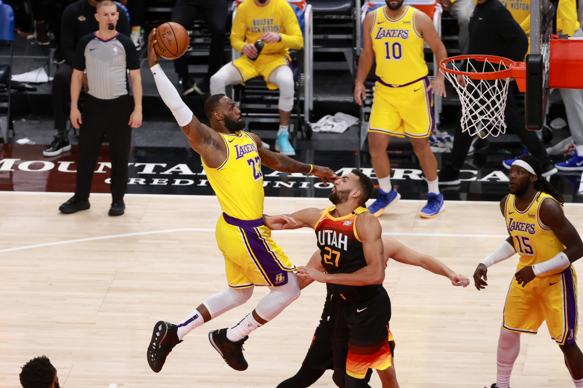 Feb 24, 2021; Salt Lake City, Utah, USA; Los Angeles Lakers forward LeBron James (23) dunks the ball over Utah Jazz center Rudy Gobert (27) during the second quarter at Vivint Smart Home Arena. Mandatory Credit: Chris Nicoll-USA TODAY Sports