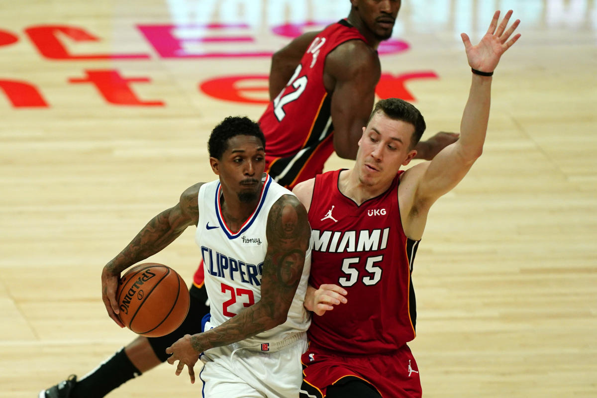 Feb 15, 2021; Los Angeles, California, USA; LA Clippers guard Lou Williams (23) passes the ball around the back of Miami Heat guard Duncan Robinson (55) in the second half at Staples Center. Mandatory Credit: Kirby Lee-USA TODAY Sports