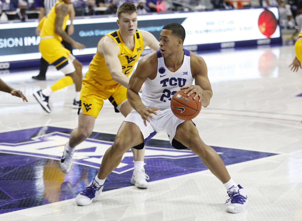 Feb 23, 2021; Fort Worth, Texas, USA; TCU Horned Frogs guard RJ Nembhard (22) dribbles against West Virginia Mountaineers guard Sean McNeil (22) during the first half at Ed and Rae Schollmaier Arena.