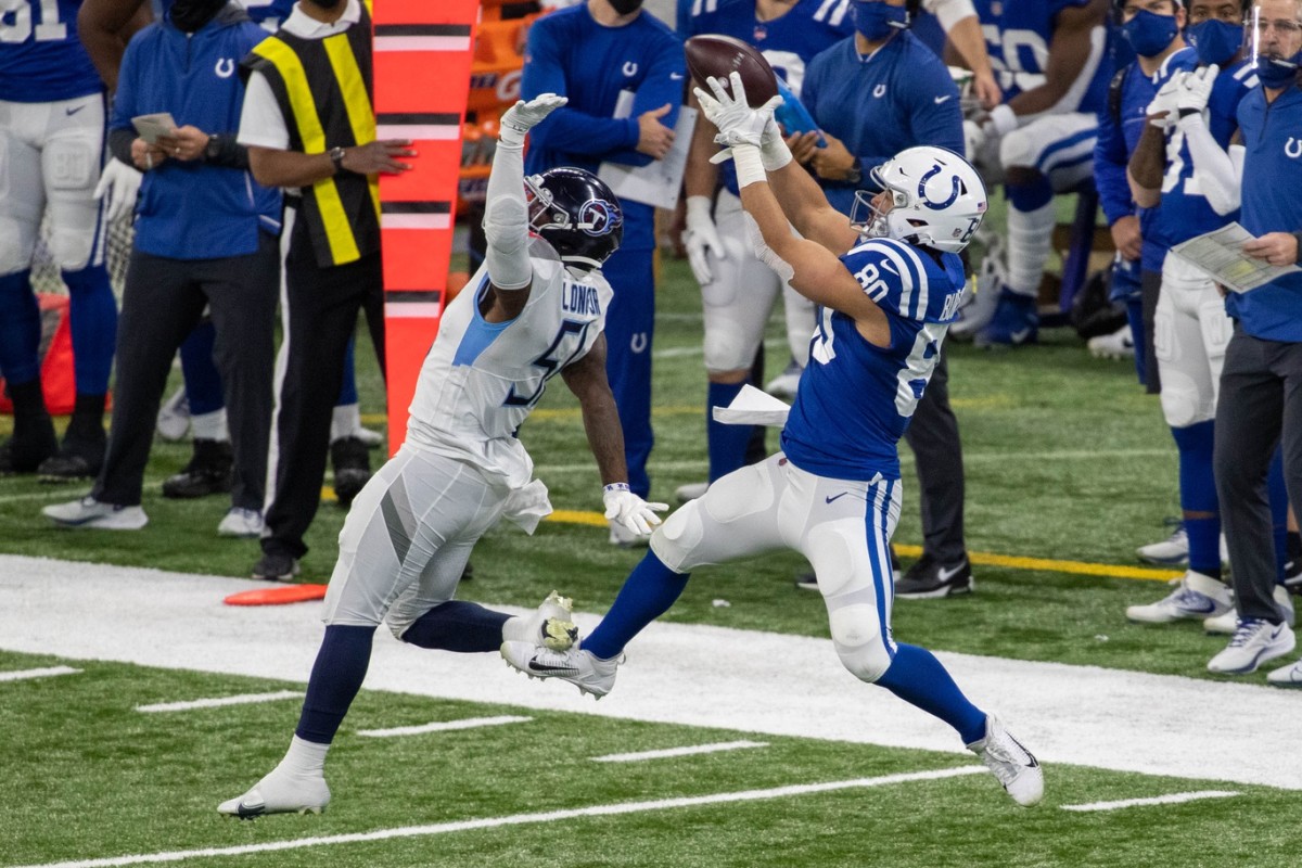 Nov 29, 2020; Indianapolis, Indiana, USA; Colts tight end Trey Burton (80) catches the ball over Titans linebacker David Long (51). Mandatory Credit: Trevor Ruszkowski-USA TODAY Sports