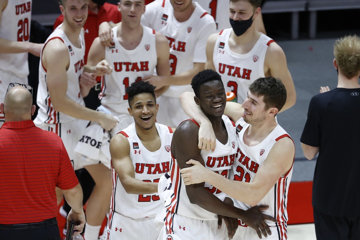 Mar 6, 2021; Salt Lake City, Utah, USA; Utah Utes center Lahat Thioune (32) is congratulated by forward Riley Battin (21) after playing in the second half against the Arizona State Sun Devils at Jon M. Huntsman Center.