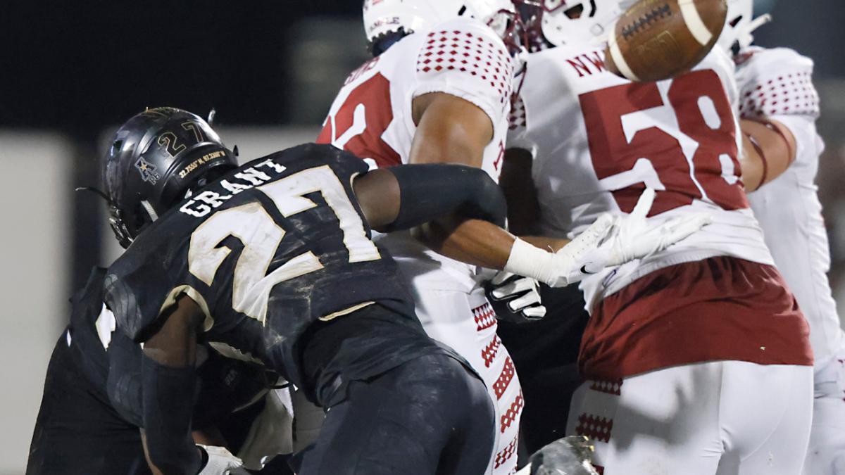 Temple Owls running back Kyle Dobbins (33) looses the ball after a hit from UCF Knights defensive back Richie Grant (27) as Owls offensive lineman David Nwaogwugwu (58) and quarterback Re-al Mitchell (13) look on during the second half at the Bounce House.