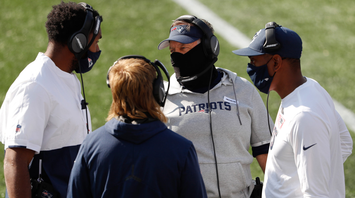 Patriots head coach Bill Belichick talks with other coaches