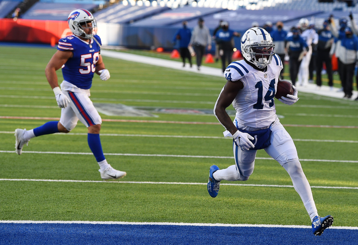 Jan 9, 2021; Orchard Park, New York, USA; Indianapolis Colts wide receiver Zach Pascal (14) runs the ball in for a touchdown ahead of Buffalo Bills outside linebacker Matt Milano (58) during the second half in the AFC Wild Card game at Bills Stadium. Mandatory Credit: Rich Barnes-USA TODAY Sports