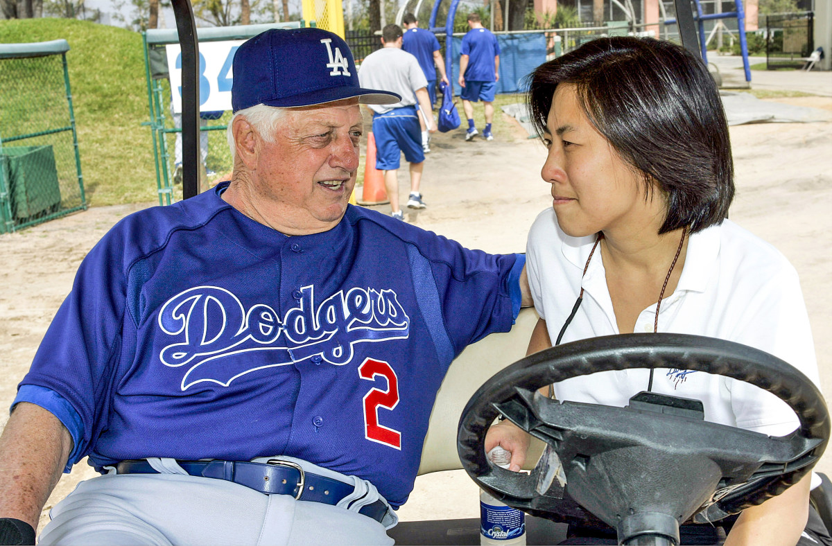 Ng, who grew up as a Yankees fan, won rings with Torre (above, right) and Cashman in New York before taking a job with Lasorda and the Dodgers (bottom).