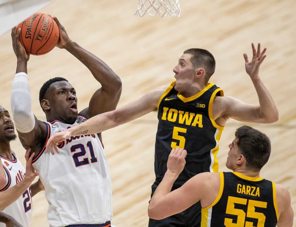 Illinois Fighting Illini center Kofi Cockburn (21) works against Iowa Hawkeyes guard CJ Fredrick (5) on Saturday, March 13, 2021, during the men's Big Ten basketball tournament from Lucas Oil Stadium. Illinois won 82-71 to set up a title game with Ohio State.