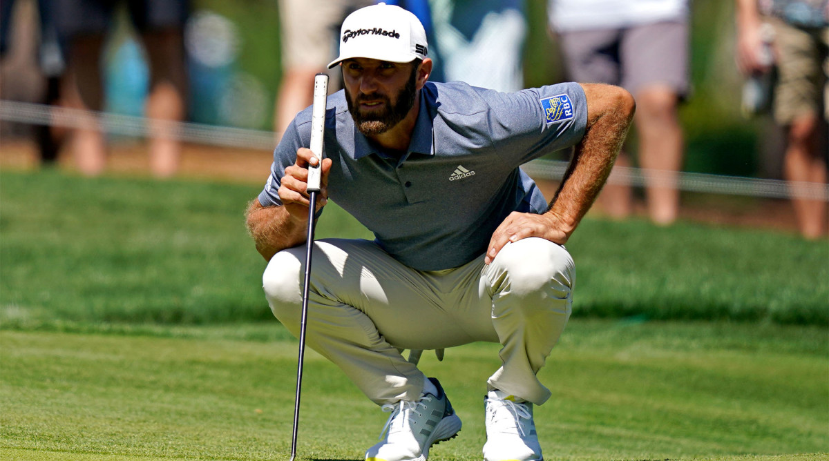 Mar 12, 2021; Ponte Vedra Beach, Florida, USA; Dustin Johnson lines up his putt on the seventh green during the second round of The Players Championship golf tournament at TPC Sawgrass - Stadium Course.
