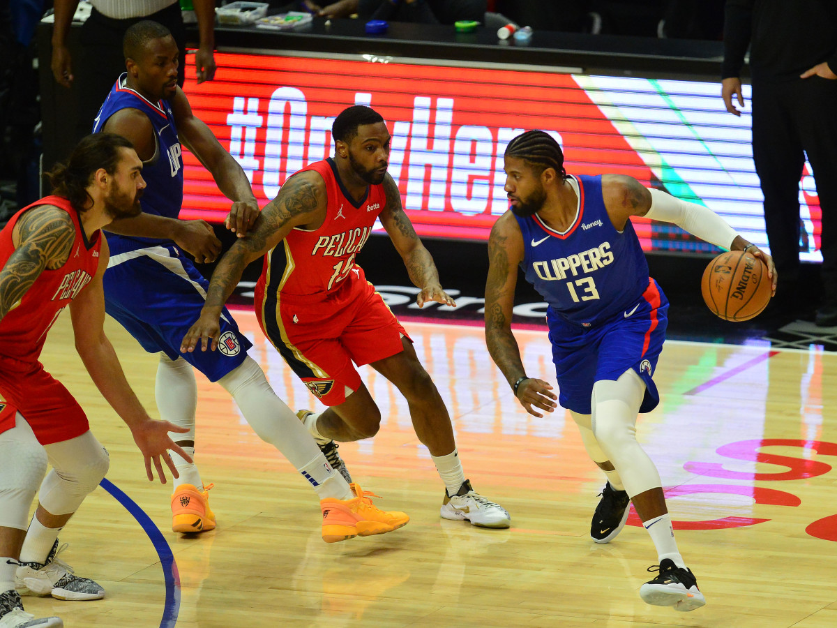 Jan 13, 2021; Los Angeles, California, USA; Los Angeles Clippers guard Paul George (13) moves the ball against New Orleans Pelicans guard Sindarius Thornwell (15) during the first half at Staples Center. Mandatory Credit: Gary A. Vasquez-USA TODAY Sports
