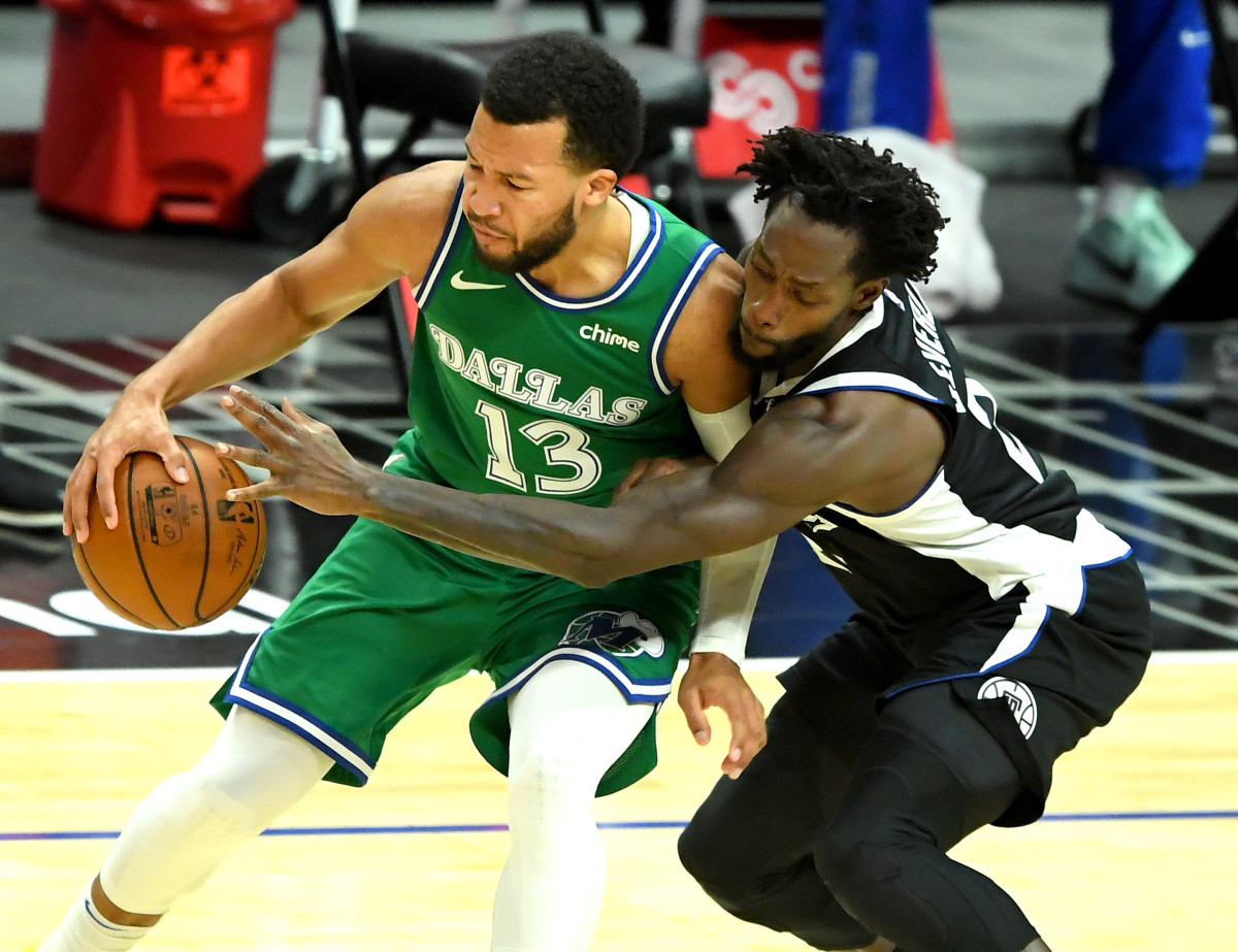 Dec 27, 2020; Los Angeles, California, USA; Dallas Mavericks guard Jalen Brunson (13) controls the ball against Los Angeles Clippers guard Patrick Beverley (21) in the first half at Staples Center. Mandatory Credit: Jayne Kamin-Oncea-USA TODAY Sports
