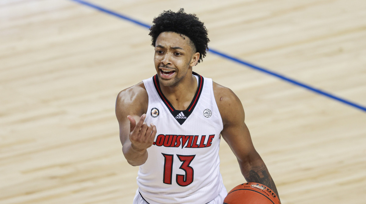 Louisville Cardinals guard David Johnson (13) directs his team against the Duke Blue Devils in the second round of the 2021 ACC tournament at Greensboro Coliseum.