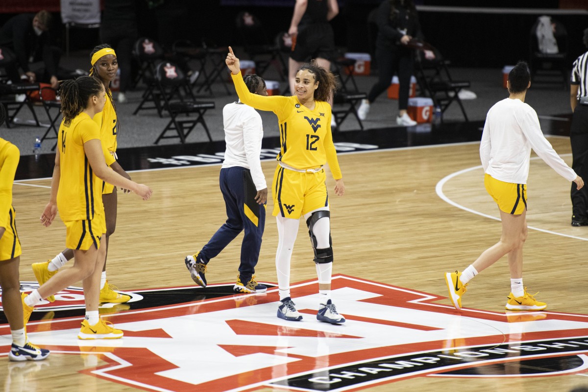 March 13, 2021; Kansas City, MO, USA; West Virginia Mountaineers forward Esmery Martinez (12) smiles after defeating the Oklahoma State Cowgirls at Municipal Auditorium.