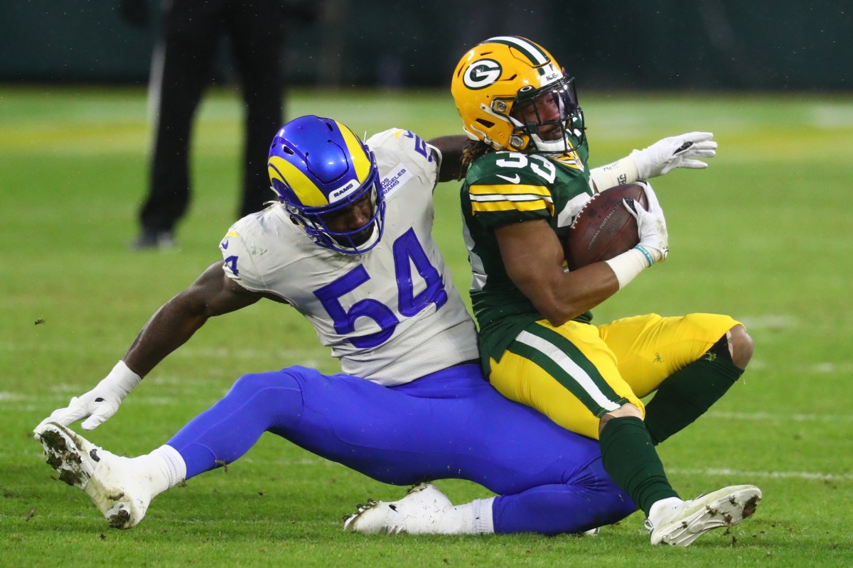 Jan 16, 2021; Green Bay, Wisconsin, USA; Los Angeles Rams linebacker Leonard Floyd (54) tackles Green Bay Packers running back Aaron Jones (33) during the first half of a NFC Divisional Round playoff game at Lambeau Field.