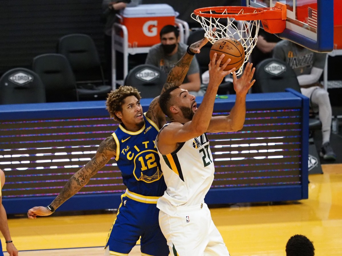 Rudy Gobert (27) goes for a layup over Kelly Oubre Jr (12) 