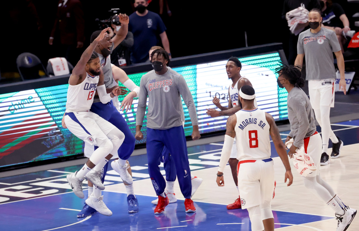 Mar 15, 2021; Dallas, Texas, USA; LA Clippers guard Paul George (13) celebrates with teammates during the fourth quarter against the Dallas Mavericks at American Airlines Center. Mandatory Credit: Kevin Jairaj-USA TODAY Sports