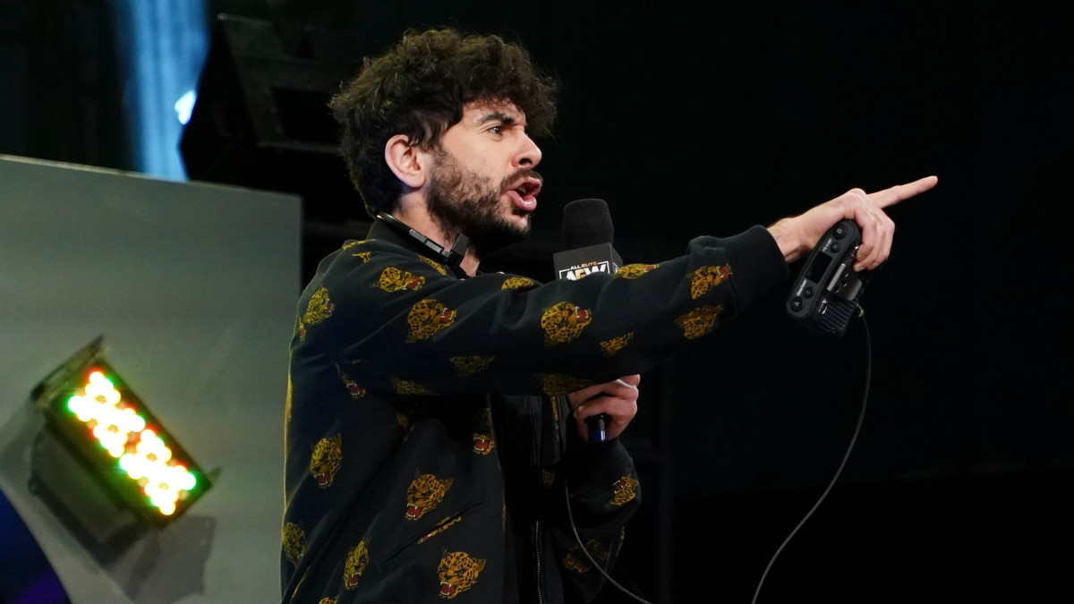 AEW president Tony Khan holds a microphone during Dynamite