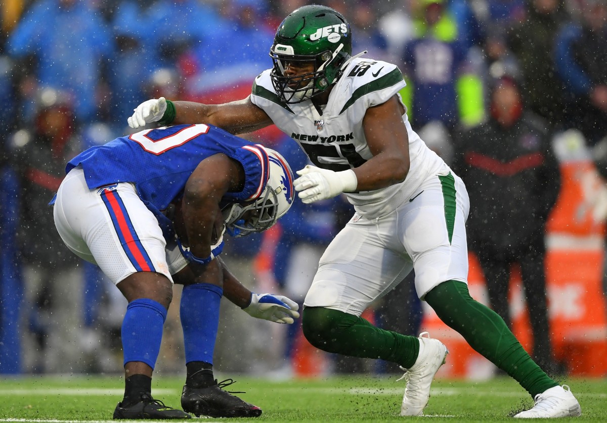 Dec 29, 2019; Orchard Park, New York, USA; Buffalo Bills running back Frank Gore (left) avoids the tackle attempt of New York Jets outside linebacker Brandon Copeland (51) during the second quarter at New Era Field.