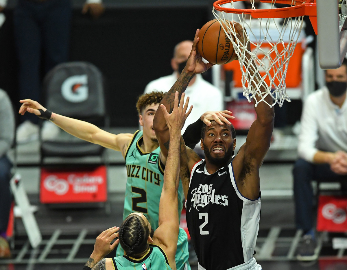 Mar 20, 2021; Los Angeles, California, USA; Los Angeles Clippers forward Kawhi Leonard (2) is fouled by Charlotte Hornets guard LaMelo Ball (2) as he goes up for a dunk in the second half of the game at Staples Center. Mandatory Credit: Jayne Kamin-Oncea-USA TODAY Sports