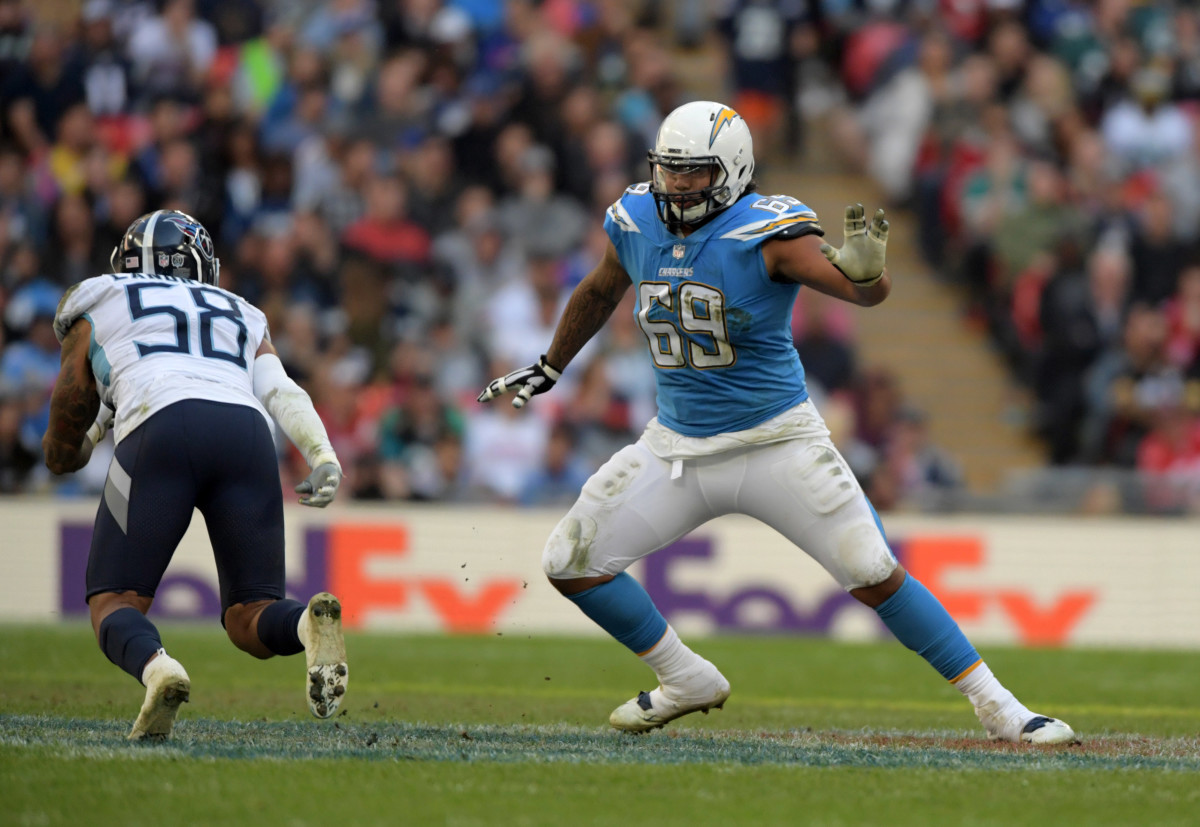 Oct 21, 2018; London, United Kingdom; Los Angeles Chargers offensive tackle Sam Tevi (69) defends against Tennessee Titans linebacker Harold Landry (58) in the second half during an NFL International Series game at Wembley Stadium. The Chargers defeated the Titans 20-19. Mandatory Credit: Kirby Lee-USA TODAY Sports