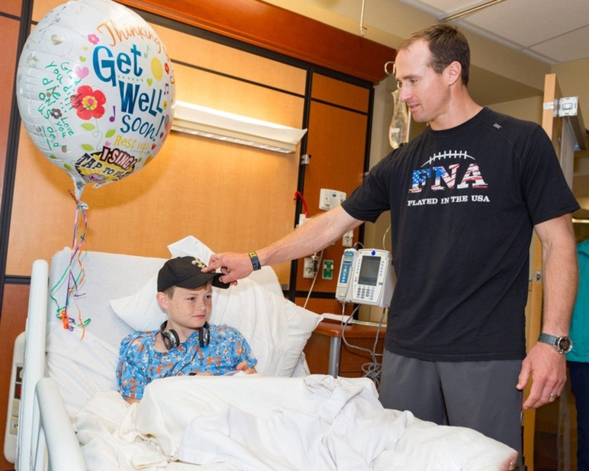 Drew Brees visiting a child at Ochsner