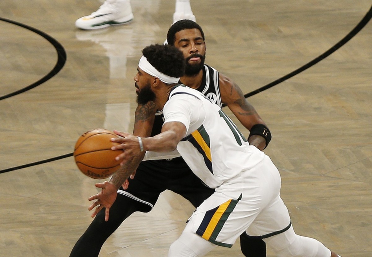 Mike Conley (10) drives against Kyrie Irving (2) in a game against the Brooklyn Nets