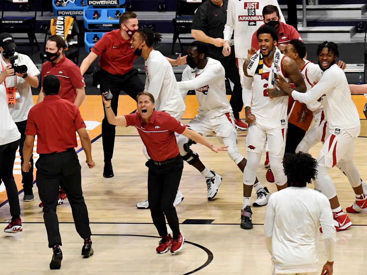 Mar 21, 2021; Indianapolis, Indiana, USA; Arkansas Razorbacks head coach Eric Musselman celebrates with his team on the court after defeating the Texas Tech Red Raiders in the second round of the 2021 NCAA Tournament at Hinkle Fieldhouse.