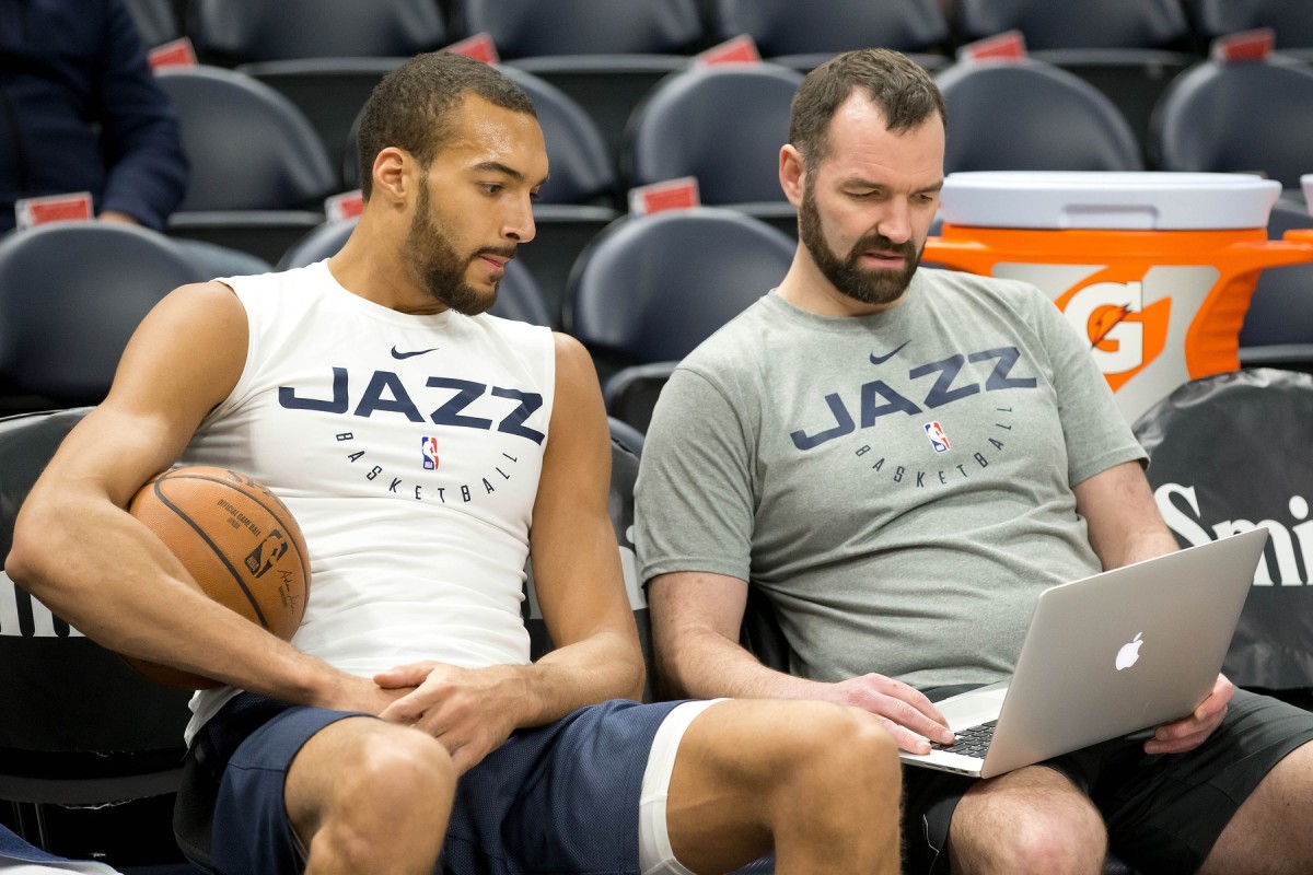Jazz assistant coach Alex Jensen (right) and Rudy Gobert (left) look at film during practice.